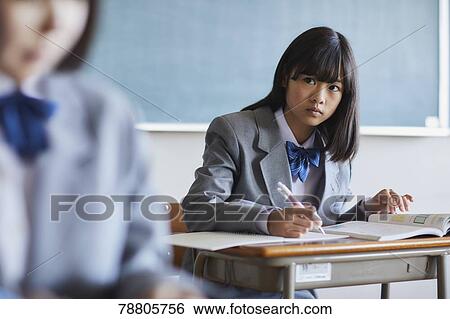Mixed-race student in the classroom View Large Photo Image Stock Photograph - Mixed-race student in the classroom. Fotosearch