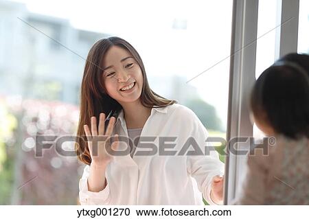 Stock Image - Mother picking up her kid at Japanese kindergarten. Fotosearch