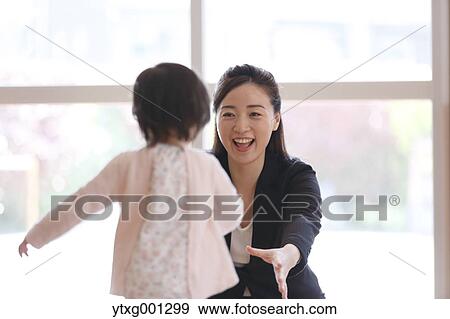 Stock Photo - Mother picking up her kid at Japanese kindergarten. Fotosearch