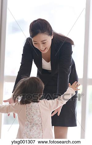 Stock Photo - Mother picking up her kid at Japanese kindergarten. Fotosearch