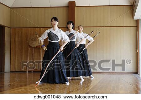 Stock Photo - Multi-ethnic group of traditional archery athletes practicing. Fotosearch
