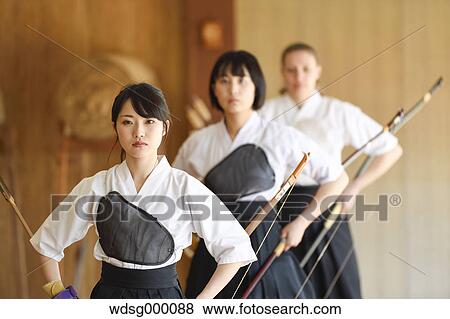 Stock Photo - Multi-ethnic group of traditional archery athletes practicing. Fotosearch