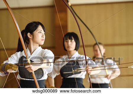 Multi-ethnic group of traditional archery athletes practicing View Large Photo Image Stock Photo - Multi-ethnic group of traditional archery athletes practicing. Fotosearch