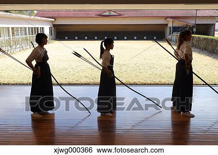 Stock Photograph - Multi-ethnic group of traditional archery athletes practicing. Fotosearch
