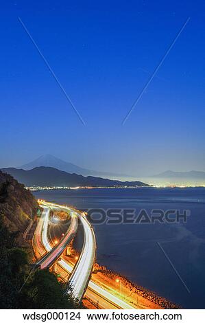 Picture - Night view of Mount Fuji and highway from Satta ridge at sunset, Shizuoka Prefecture, Japan. Fotosearch