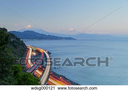 Stock Image - Night view of Mount Fuji and highway from Satta ridge at sunset, Shizuoka Prefecture, Japan. Fotosearch