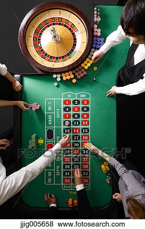 People betting at casino table View Large Photo Image Stock Photo - People betting at casino table. Fotosearch
