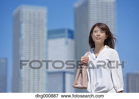 Portrait of young Japanese woman downtown Tokyo, Japan View Large Photo Image Stock Photo - Portrait of young Japanese woman downtown Tokyo, Japan. Fotosearch