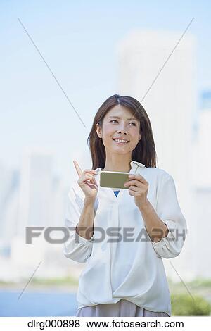 Portrait of young Japanese woman downtown Tokyo, Japan View Large Photo Image Stock Photo - Portrait of young Japanese woman downtown Tokyo, Japan. Fotosearch