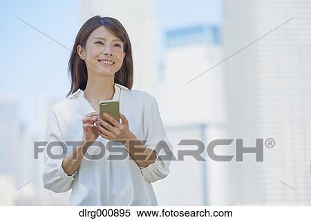 Portrait of young Japanese woman downtown Tokyo, Japan View Large Photo Image Stock Photography - Portrait of young Japanese woman downtown Tokyo, Japan. Fotosearch