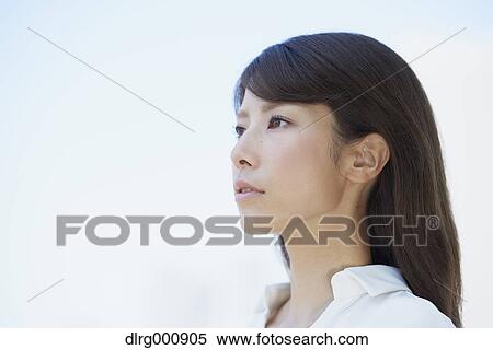Stock Photography - Portrait of young Japanese woman downtown Tokyo, Japan. Fotosearch