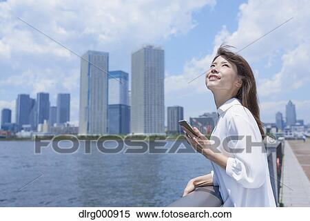 Portrait of young Japanese woman downtown Tokyo, Japan View Large Photo Image Stock Photography - Portrait of young Japanese woman downtown Tokyo, Japan. Fotosearch