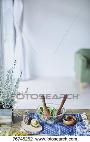 Stock Image - Salad on wooden table. Fotosearch