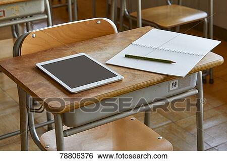 School desk notebook and tablet View Large Photo Image Stock Photograph - School desk notebook and tablet. Fotosearch