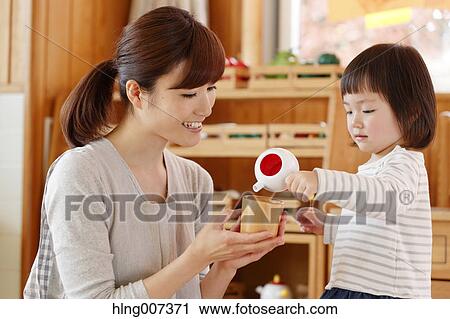 Stock Image - Teacher with kid at Japanese kindergarten. Fotosearch