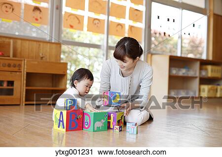 Teacher with kid at Japanese kindergarten View Large Photo Image Stock Image - Teacher with kid at Japanese kindergarten. Fotosearch