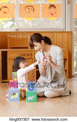 Teacher with kid at Japanese kindergarten View Large Photo Image Stock Photo - Teacher with kid at Japanese kindergarten. Fotosearch
