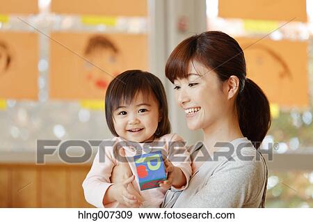 Teacher with kid at Japanese kindergarten View Large Photo Image Stock Photo - Teacher with kid at Japanese kindergarten. Fotosearch