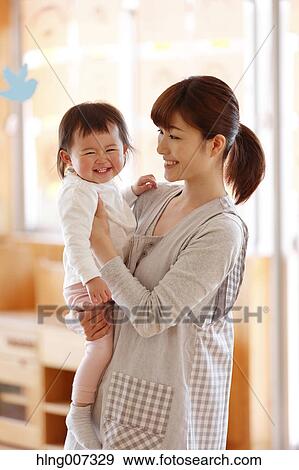 Stock Photo - Teacher with kid at Japanese kindergarten. Fotosearch