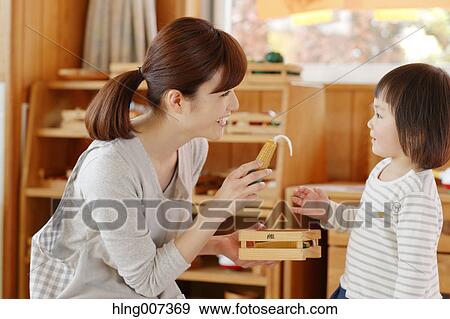 Teacher with kid at Japanese kindergarten View Large Photo Image Stock Photo - Teacher with kid at Japanese kindergarten. Fotosearch
