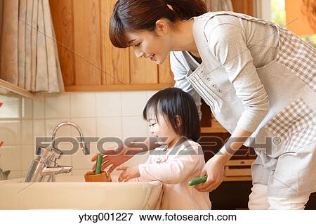 Stock Photo - Teacher with kid at Japanese kindergarten. Fotosearch