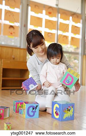 Teacher with kid at Japanese kindergarten View Large Photo Image Stock Photo - Teacher with kid at Japanese kindergarten. Fotosearch