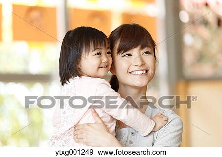 Stock Photo - Teacher with kid at Japanese kindergarten. Fotosearch