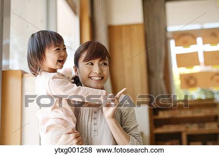 Stock Photo - Teacher with kid at Japanese kindergarten. Fotosearch