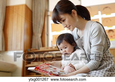 Stock Photo - Teacher with kid at Japanese kindergarten. Fotosearch
