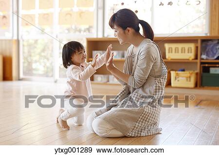 Teacher with kid at Japanese kindergarten View Large Photo Image Stock Photo - Teacher with kid at Japanese kindergarten. Fotosearch