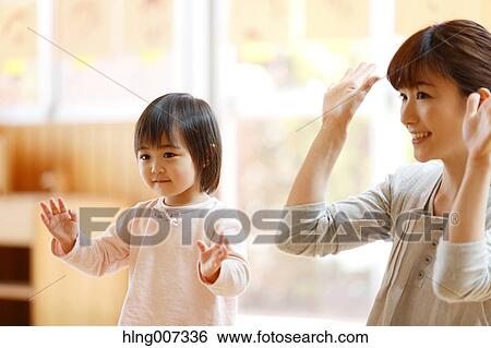 Stock Photograph - Teacher with kid at Japanese kindergarten. Fotosearch