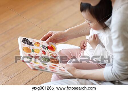 Stock Photography - Teacher with kid at Japanese kindergarten. Fotosearch