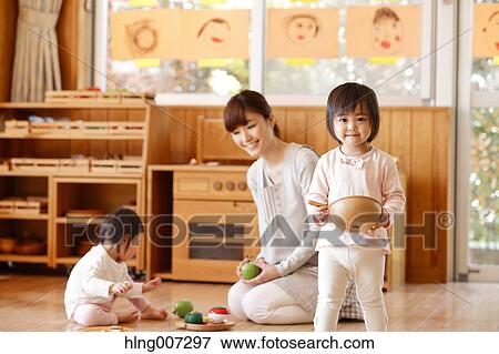 Teacher with kids at Japanese kindergarten View Large Photo Image Stock Photo - Teacher with kids at Japanese kindergarten. Fotosearch