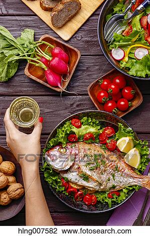 Woman hand grabbing wine from wooden table with colorful dishes View Large Photo Image Stock Image - Woman hand grabbing wine from wooden table with colorful dishes. Fotosearch
