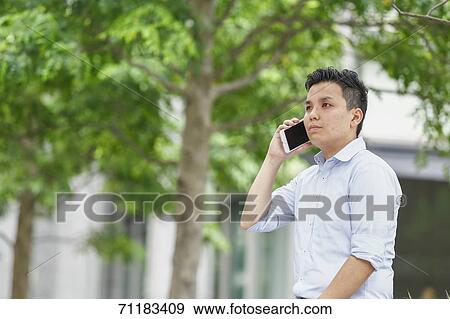 Young Japanese businessman downtown Tokyo View Large Photo Image Stock Photo - Young Japanese businessman downtown Tokyo. Fotosearch