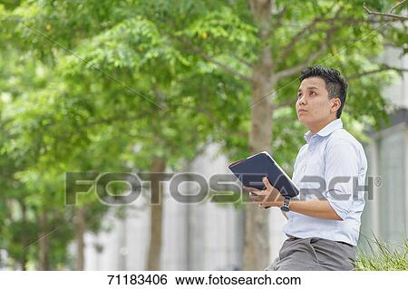 Stock Photograph - Young Japanese businessman downtown Tokyo. Fotosearch