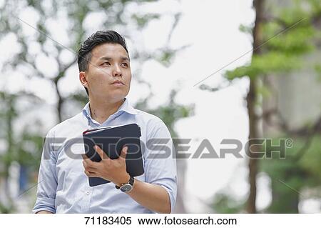Young Japanese businessman downtown Tokyo View Large Photo Image Stock Photography - Young Japanese businessman downtown Tokyo. Fotosearch