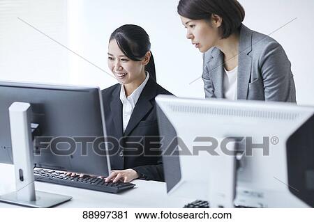 Stock Image - Young Japanese businesspeople. Fotosearch