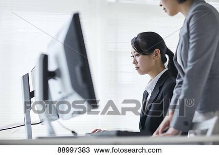 Stock Image - Young Japanese businesspeople. Fotosearch