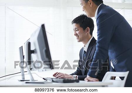 Stock Photograph - Young Japanese businesspeople. Fotosearch