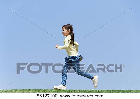 Stock Image - Young Japanese girl and blue sky. Fotosearch
