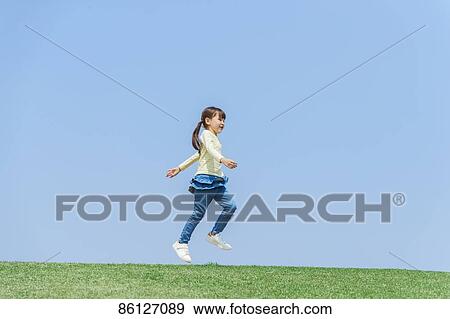 Stock Photo - Young Japanese girl and blue sky. Fotosearch