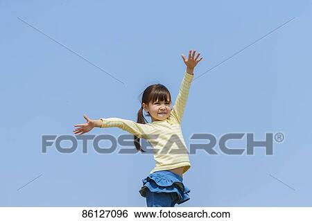 Stock Photograph - Young Japanese girl and blue sky. Fotosearch