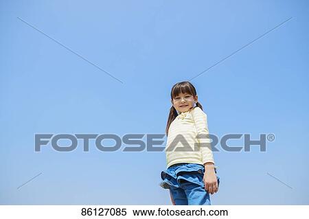 Stock Photography - Young Japanese girl and blue sky. Fotosearch