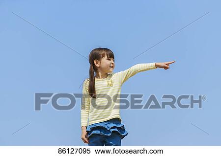 Stock Photography - Young Japanese girl and blue sky. Fotosearch