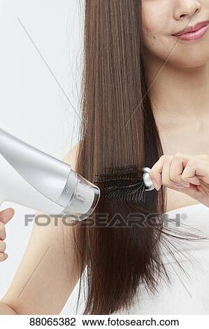Stock Image - Young Japanese model with beautiful hair. Fotosearch