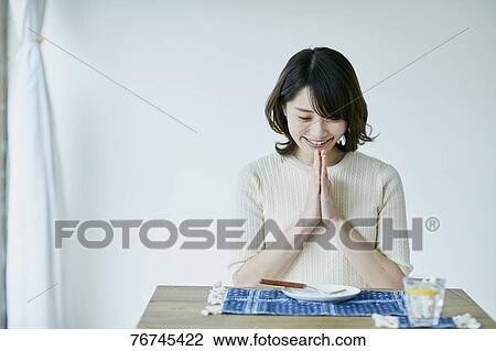 Young Japanese sitting at dining table View Large Photo Image Stock Image - Young Japanese sitting at dining table. Fotosearch