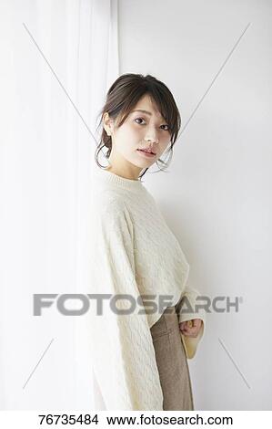 Young Japanese woman against white wall View Large Photo Image Picture - Young Japanese woman against white wall. Fotosearch