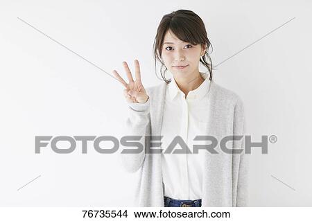Young Japanese woman against white wall View Large Photo Image Picture - Young Japanese woman against white wall. Fotosearch