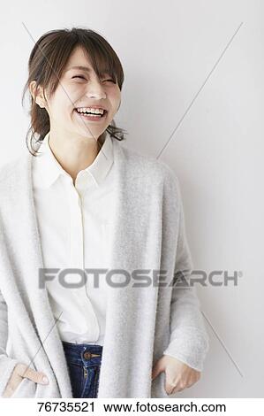 Young Japanese woman against white wall View Large Photo Image Stock Image - Young Japanese woman against white wall. Fotosearch